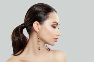 Pretty Young Woman with Makeup, Dark Hairstyle and Earrings, Fashion Portrait